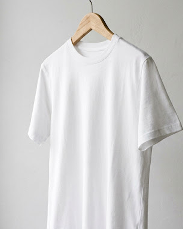 White t-shirt hanging on a wooden hanger